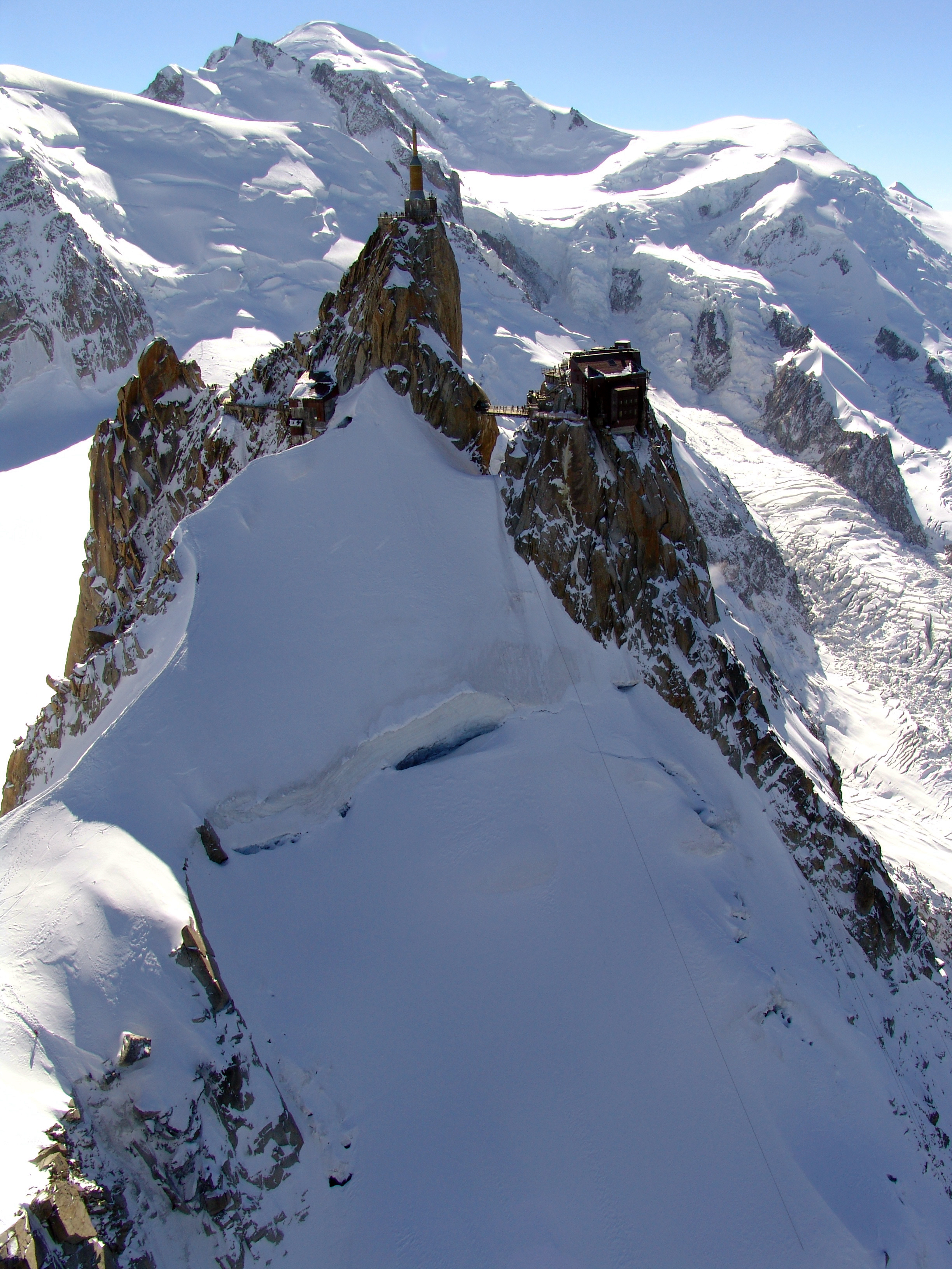 The_Aiguille_du_Midi_3842_m_a.s.l._seen_from_the_East_with_the_Mont_Blanc_summit_in_the_.JPG